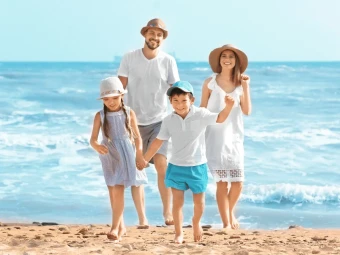 A joyful family vacationing at the peaceful coast and making priceless memories.